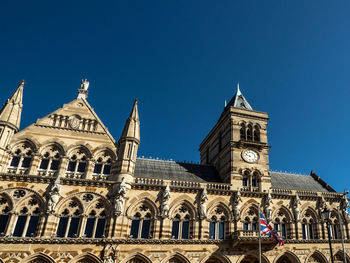 Low angle view of historic building against clear blue sky