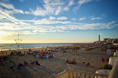 People on beach against sky