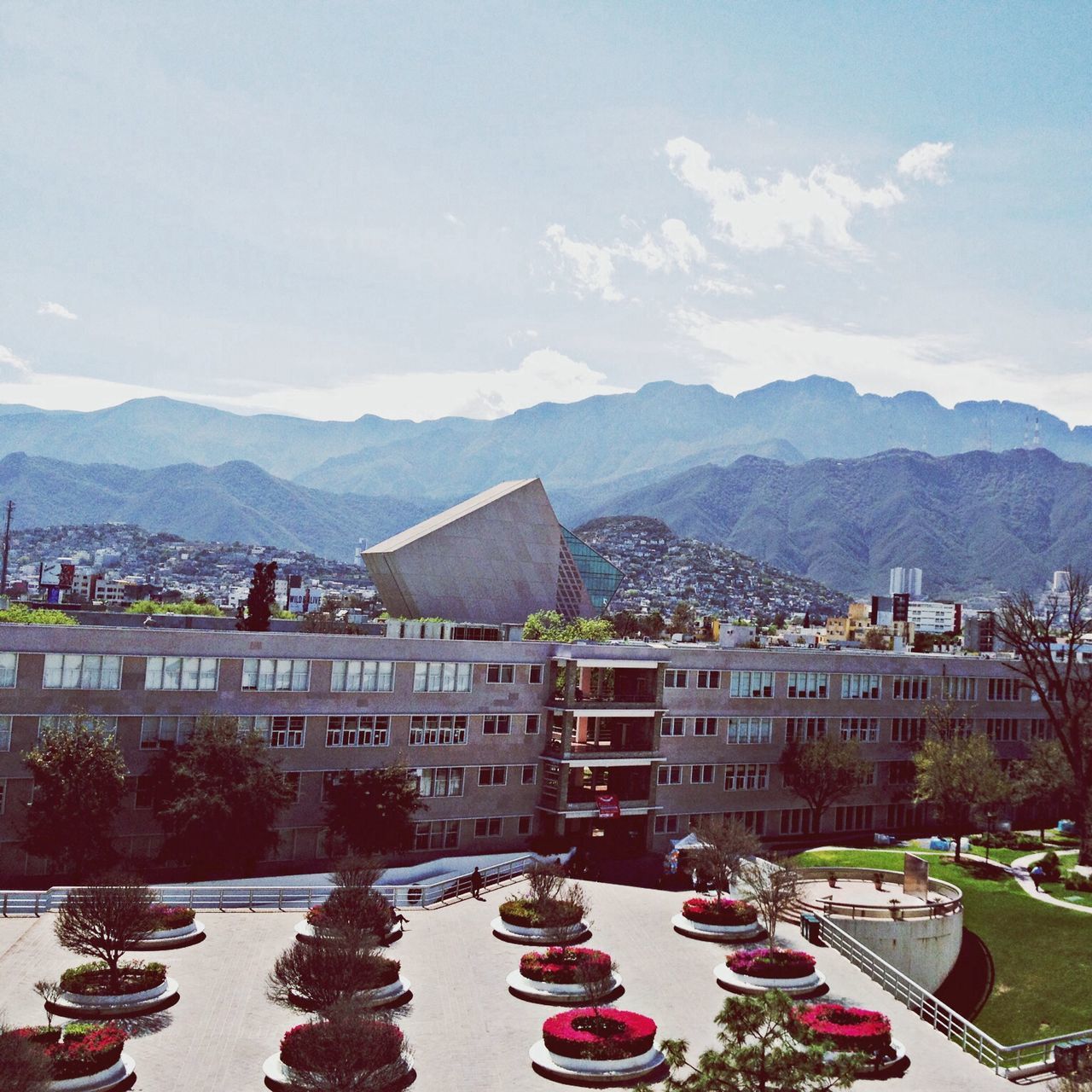 mountain, architecture, building exterior, built structure, water, mountain range, sky, house, residential structure, town, river, residential building, tree, lake, cloud - sky, day, nature, outdoors, cloud, townscape