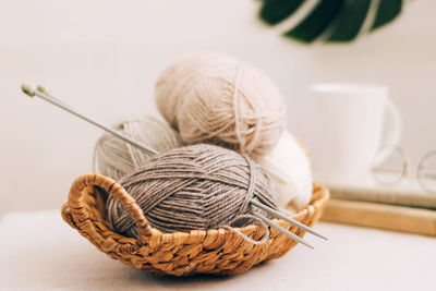 Close-up of wool in wicker basket on table