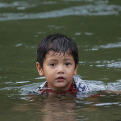 Portrait of boy swimming in water