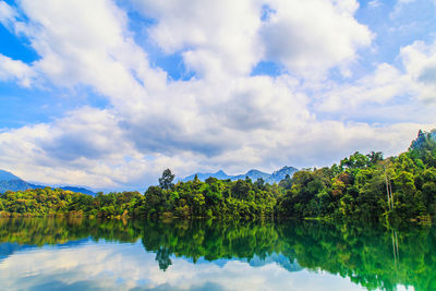 Scenic view of lake by trees against sky