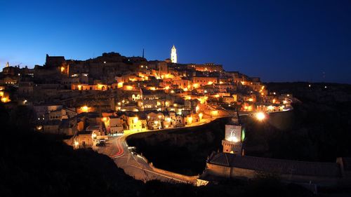 High angle view of illuminated buildings against clear sky at night