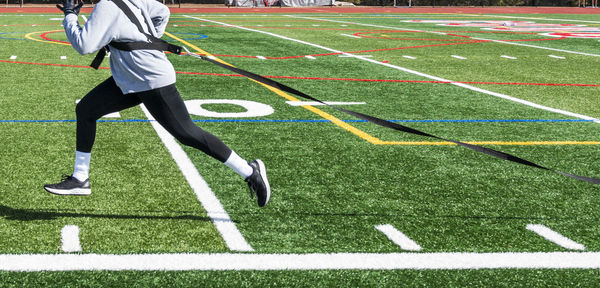 Low section of man running on grass