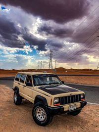 Vintage car against sky during sunset