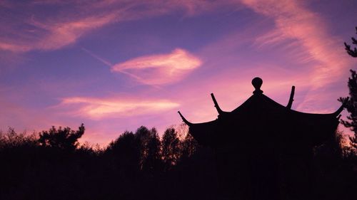 Low angle view of silhouette trees against sky at sunset