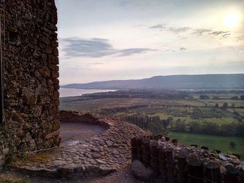 Scenic view of landscape against cloudy sky