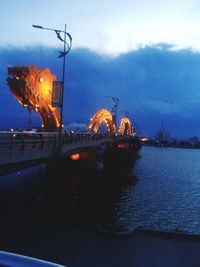 View of illuminated city at riverbank