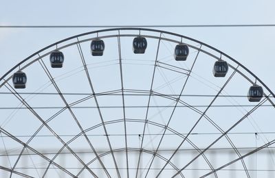 Low angle view of ferris wheel against sky