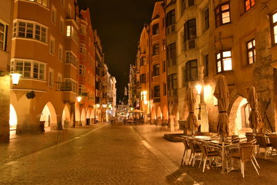 View of illuminated street and buildings at night