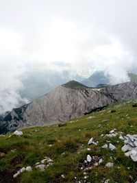 Scenic view of mountains against cloudy sky