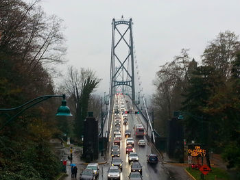 Traffic on road in city against sky