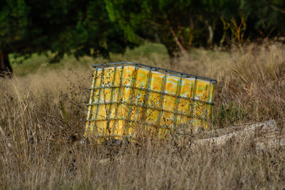 Close-up of rusty metallic structure on field