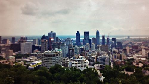 Cityscape against cloudy sky