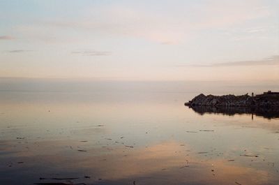 Scenic view of sea against sky at sunset