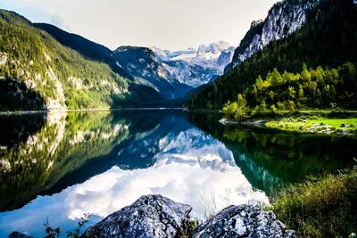 Scenic view of calm lake with mountains reflection