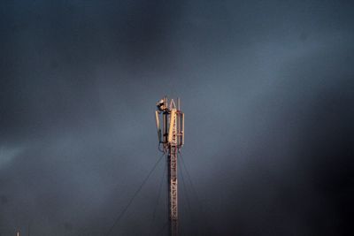 Low angle view of communications tower against sky