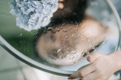 Close-up of woman holding ice cream in glass