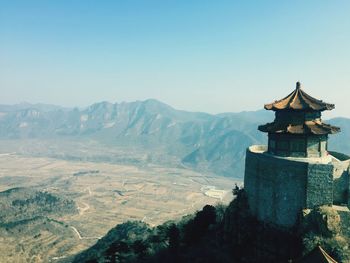 Statue on mountain against clear sky