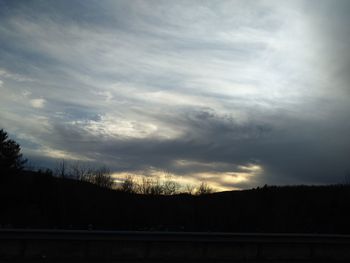 Silhouette of landscape against cloudy sky