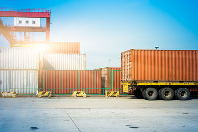 Stack of truck on pier against sky