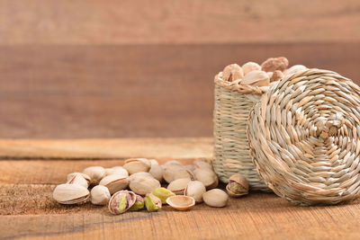 Pistachios in wicker basket on table