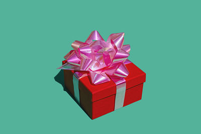 Red gift box against green background