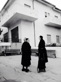 Full length of woman standing in front of building