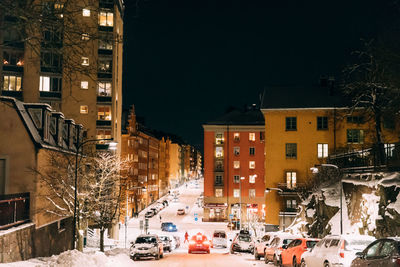 Cars on road in city during winter