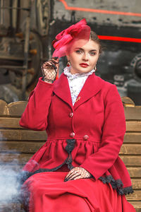 Portrait of young woman standing in train