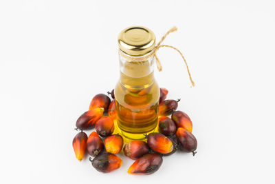 Various fruits in glass jar on white background