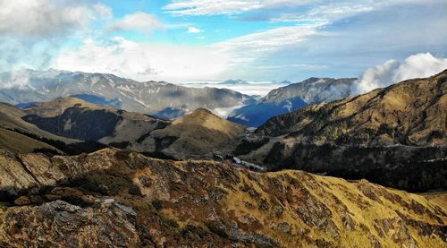 Scenic view of mountains against cloudy sky