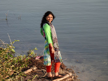 Portrait of smiling woman standing in lake