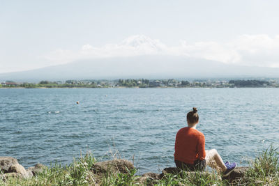 Rear view of woman looking at lake