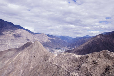 Scenic view of mountains against cloudy sky