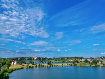 Scenic view of river against blue sky