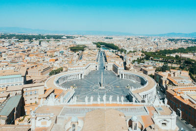 Aerial view of cityscape against sky during sunny day