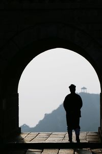 Silhouette man standing on mountain against clear sky