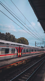 Train at railroad station against sky