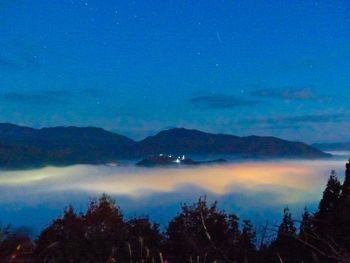 Scenic view of mountains against sky at night