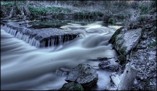 River flowing through rocks in forest