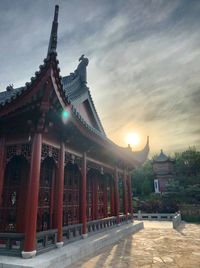 Traditional building against sky during sunset