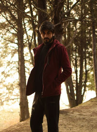 Young man standing in forest