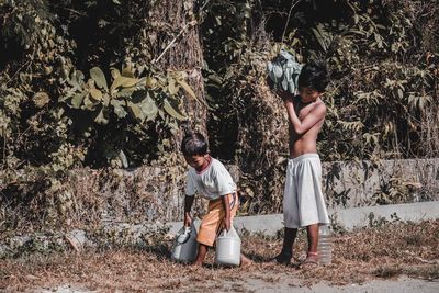 Rear view of people in forest