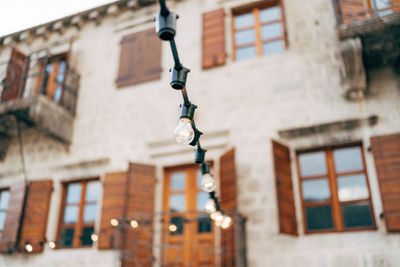 Low angle view of street light against building