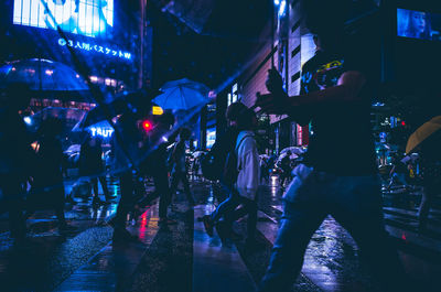 People at illuminated city at night