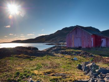 Norwegian coast landscape with a typical red house. wooden red house on the seaside,  spring day.
