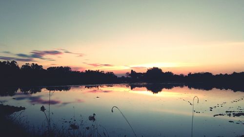 Scenic view of lake against sky during sunset