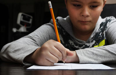 Close-up portrait of boy sitting on table