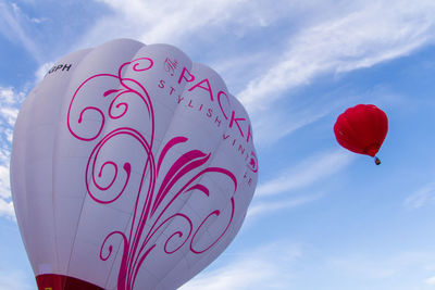 Low angle view of heart shape balloon against sky